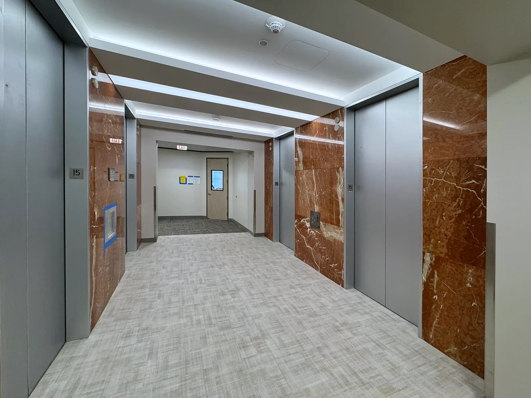 Elevator lobby with cove lighting installed by Texas A&E